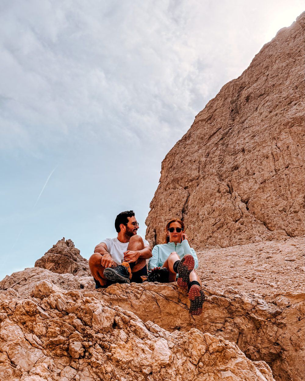 Filipa and Lu&iacute;s resting on the rocks in the Dolomites